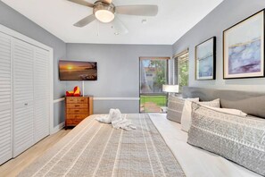 A bedroom with a bed, a dresser, a ceiling fan, and artwork on the walls. - Idyllic Boca Pool Home: 4/2.5 + Study-FAU & Mizner (Boca Raton)