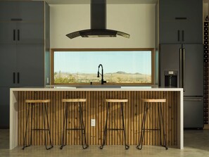 Indulge your culinary desires in our gourmet kitchen, a haven for food lovers and entertainers alike. This meticulously designed space is a chef's dream, boasting high-end appliances, a large island, and an Italian Bertazzoni induction range!