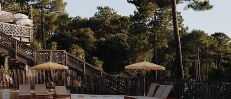 Seasonal outdoor pool, open 10:00 AM to 8:00 PM, pool umbrellas