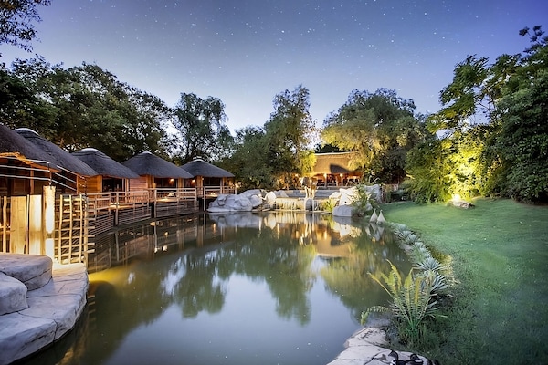 Escape to a tranquil lagoon setting under starlit skies.