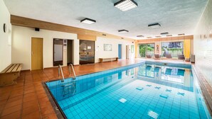 A swimming pool with a tiled floor, a wooden bench, and a door leading to another room. - Apartment 'Mignon B' with Mountain View, Shared Garden and Wi-Fi (Riffian)