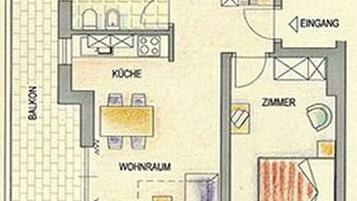 Ein Hotelzimmer mit Küchenzeile, Essbereich und Wohnbereich.