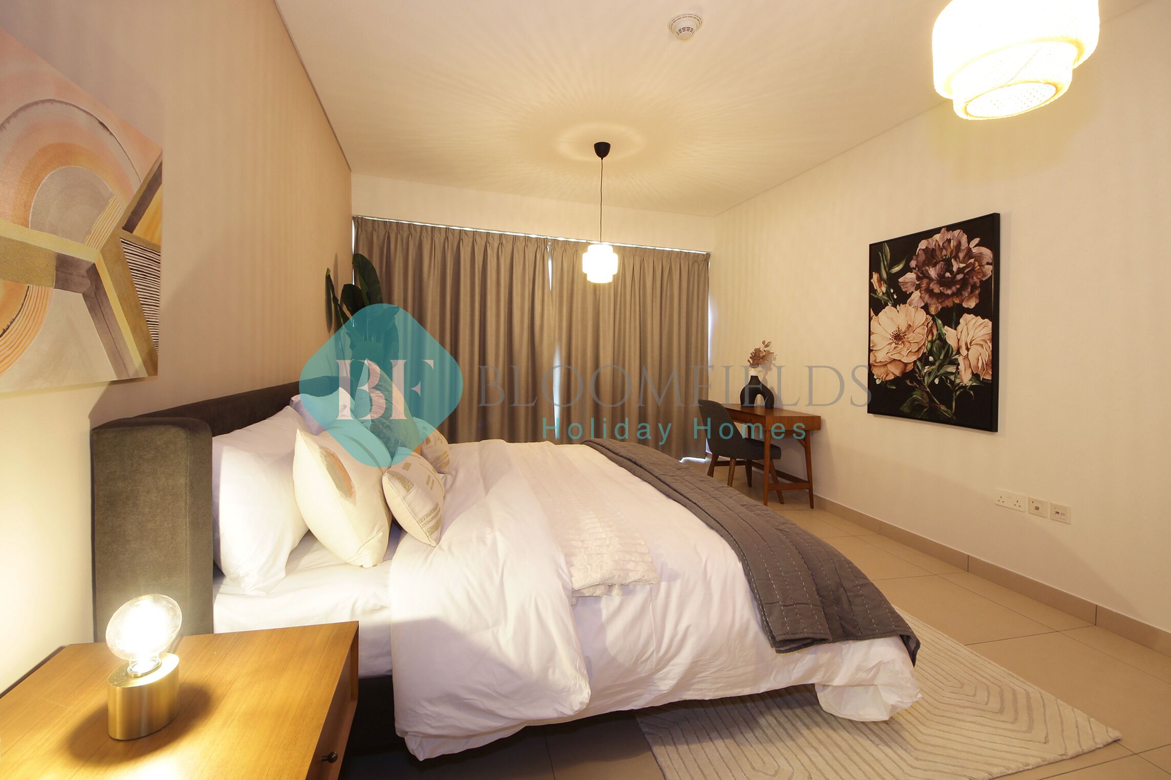 A hotel room with a bed, a nightstand, a lamp, a painting, and a window with curtains.