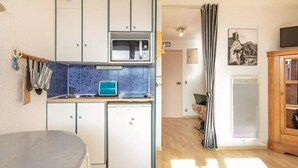 A compact kitchen with a microwave, refrigerator, and a small sink. - Lovely vacation home Séjour grand ski (Huez)
