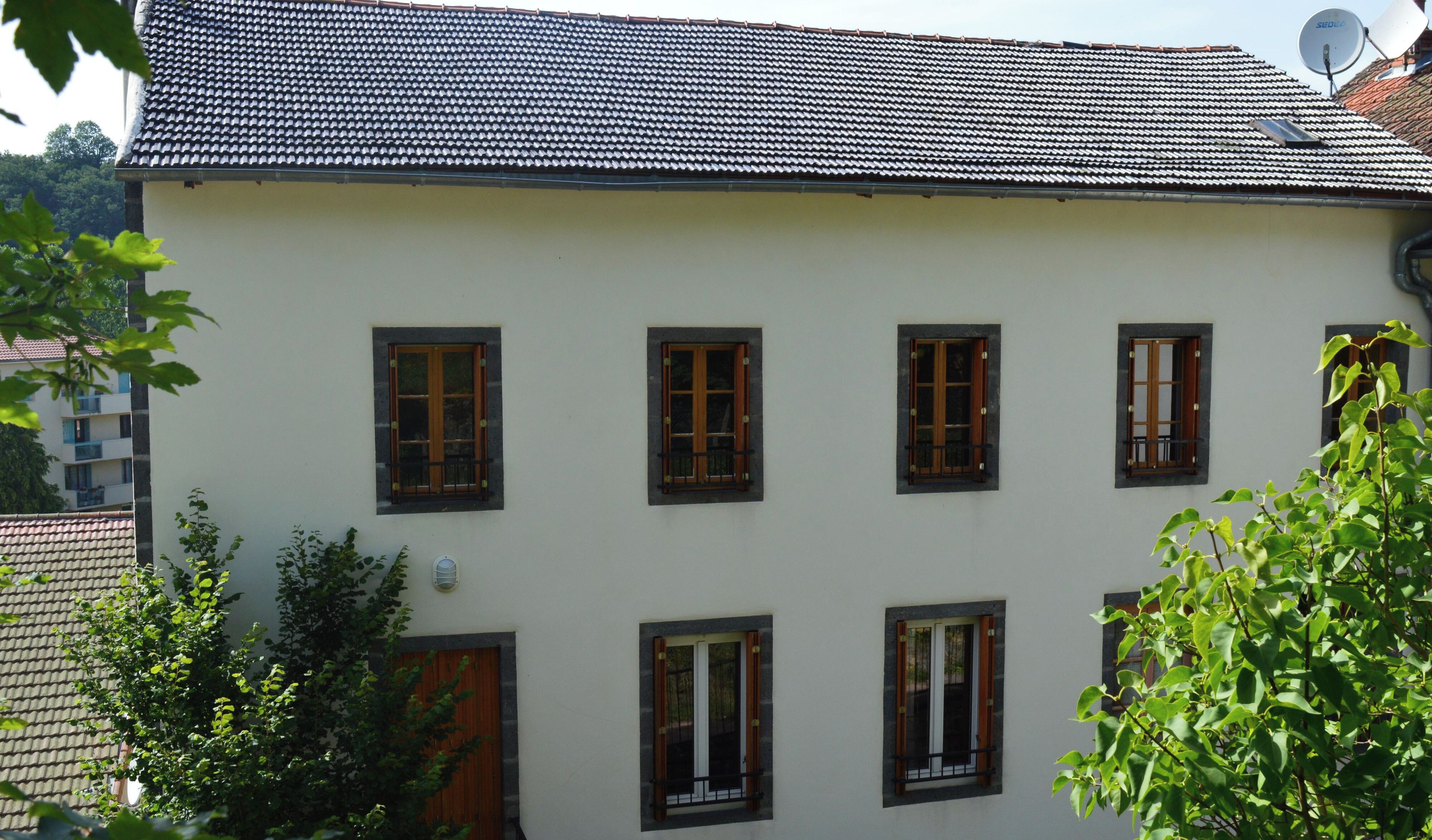 A building with multiple windows and a tiled roof.