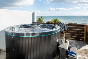 A hot tub with a clear view of the ocean.