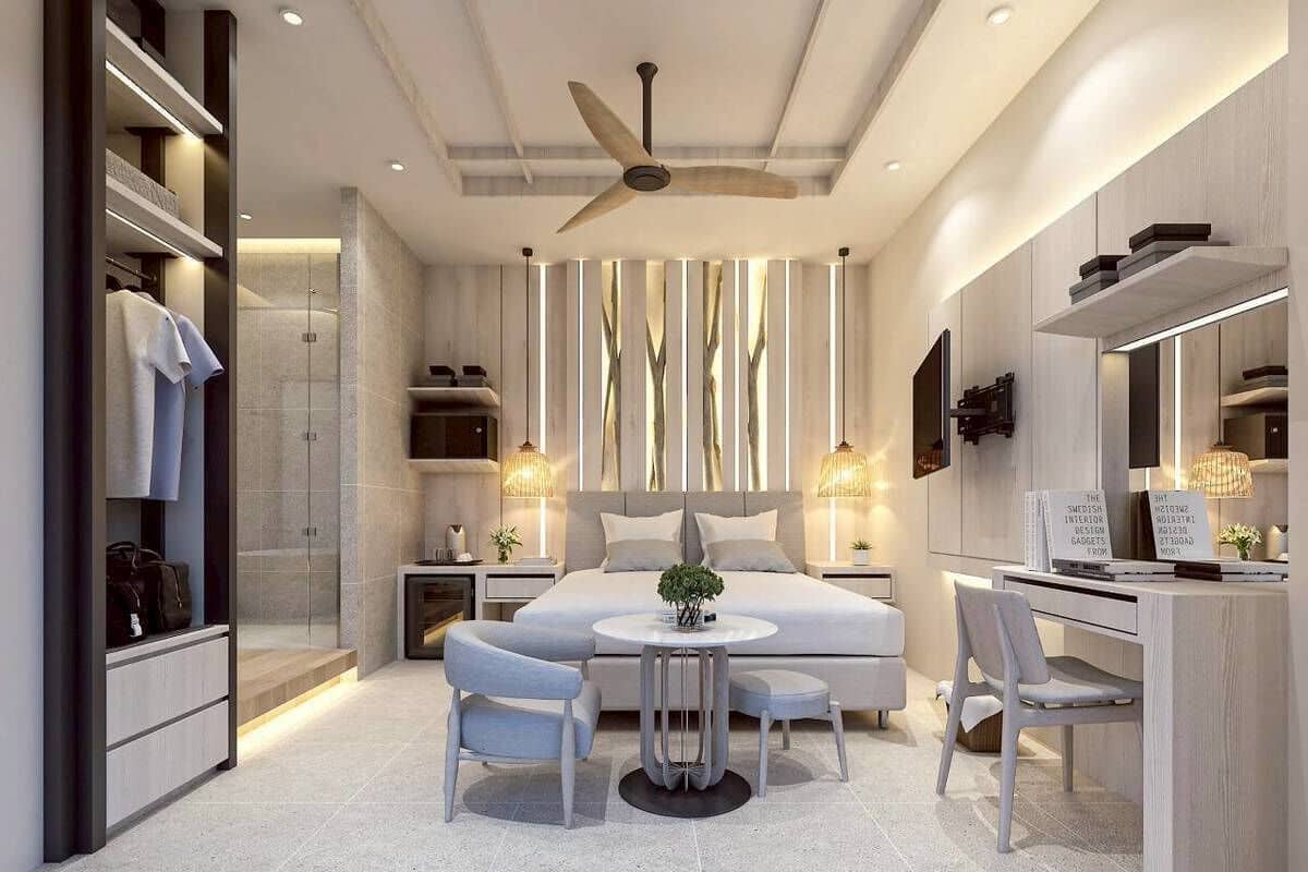A modern bedroom with a bed, bedside tables, a desk, and a chair.