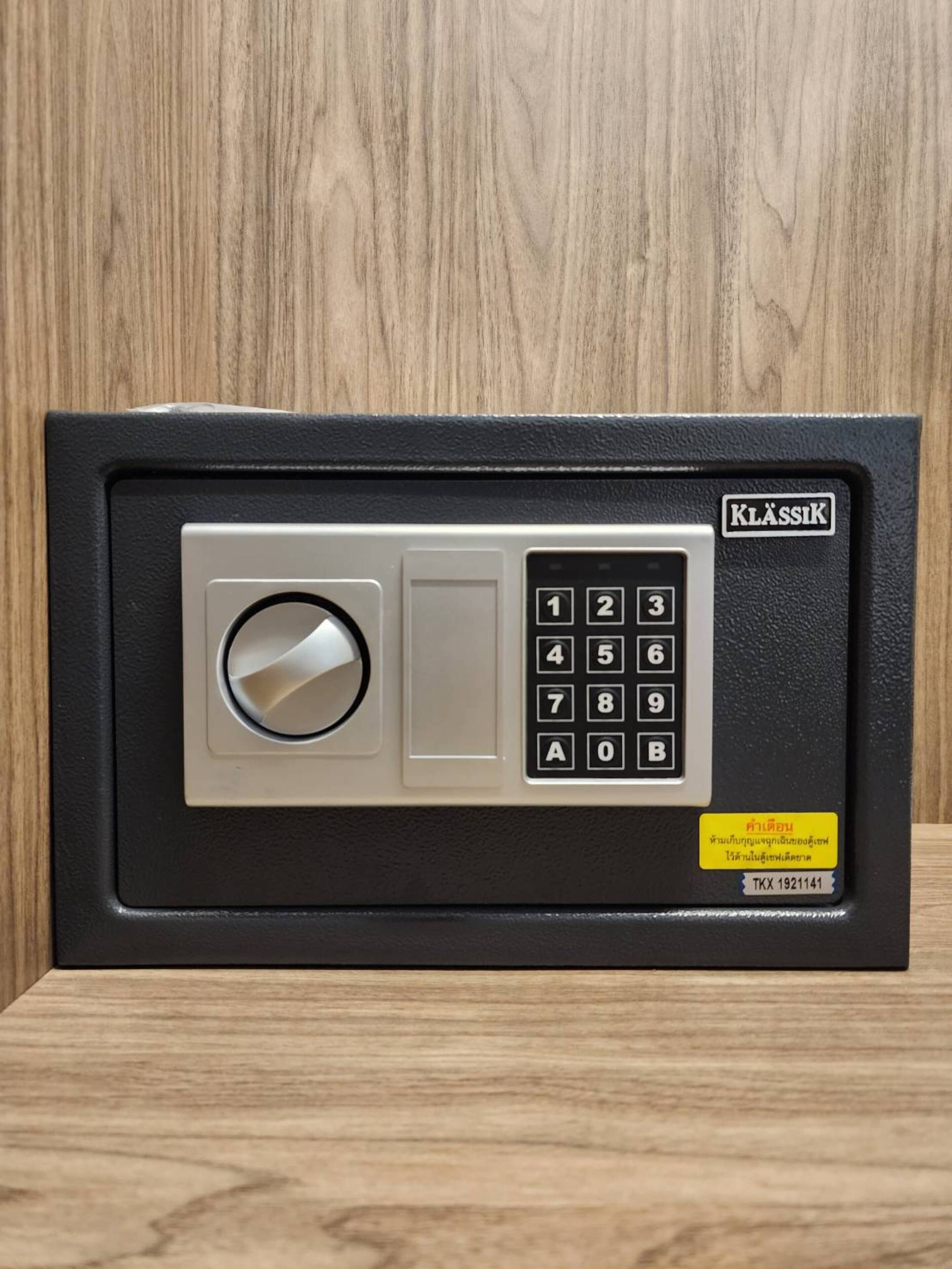 A black safe with a numeric keypad and a combination dial, labeled "KLASSIK."