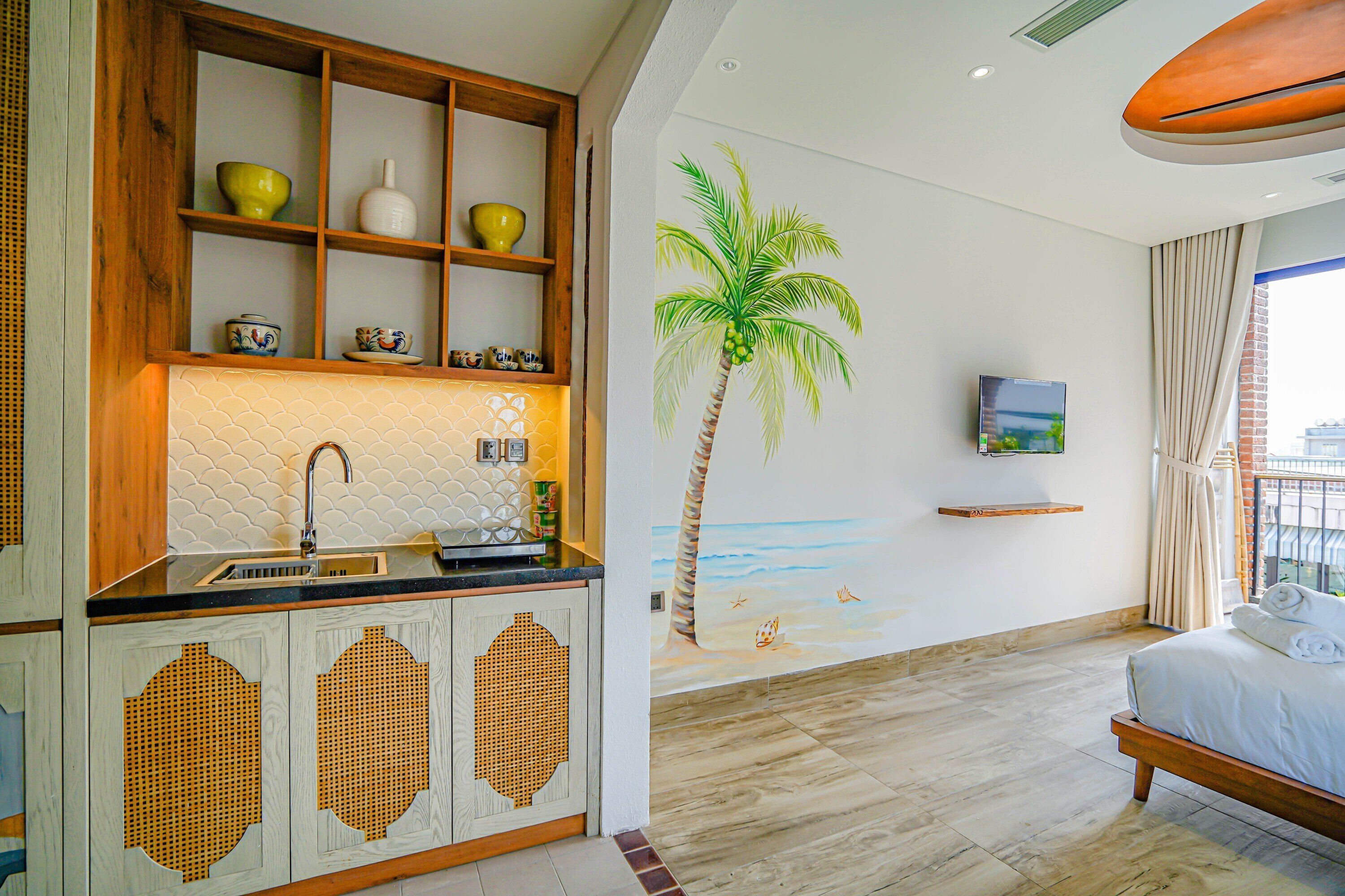 A modern hotel room with a wooden cabinet, a sink, a bed, and a mural of a palm tree.
