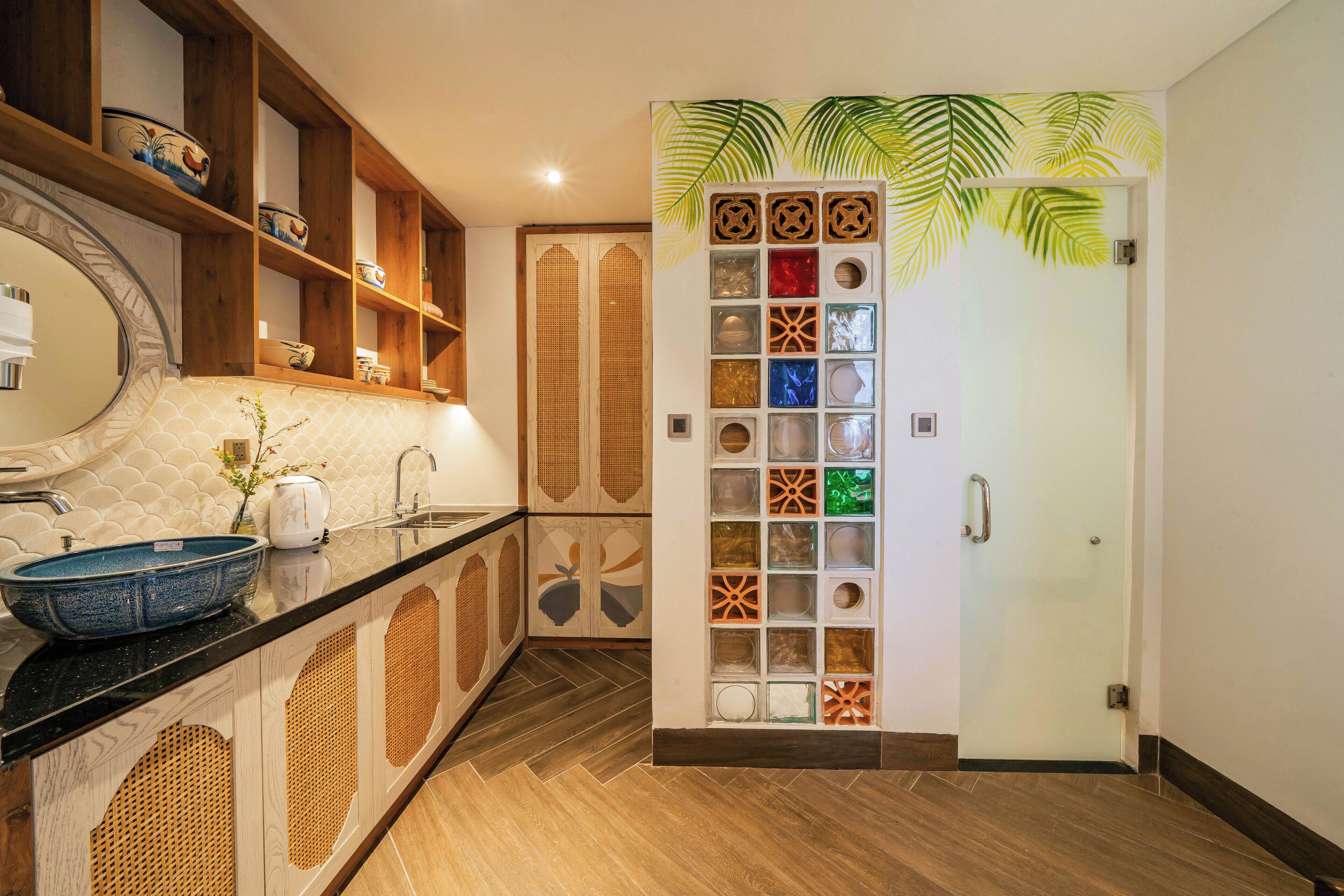 A kitchen with a large island, wooden cabinets, and a decorative wall panel.
