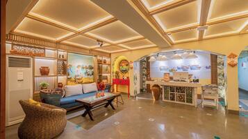 A spacious lobby with a reception desk, seating area, and decorative elements.