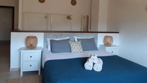 A bedroom with a bed, two bedside tables, a headboard, and a mirror. - Private villa with breathtaking views and private pool. (Port de Sóller)