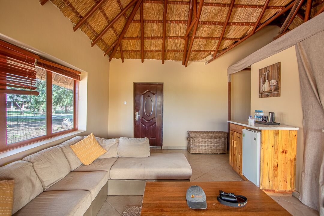 A cozy living area with a sofa, a coffee table, and a kitchenette.