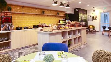 A modern restaurant with a brick wall, a bar area, and a seating section with tables and chairs.