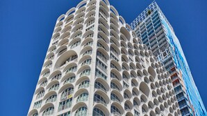A high-rise building with a distinctive architectural design featuring rounded balconies and a modern facade. - Appart Hotel Odalys City Marseille Centre Euromed (Marseille)