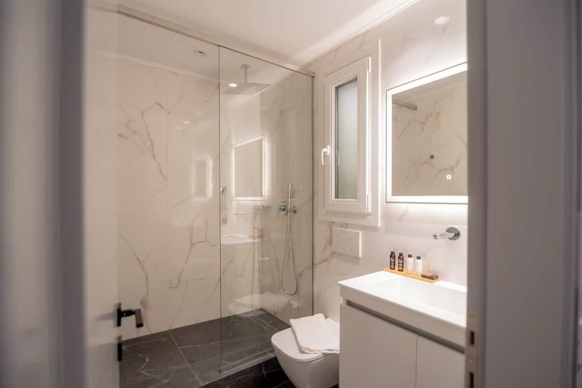deluxe studio | bathroom | shower, rainfall showerhead, designer toiletries, hair dryer
