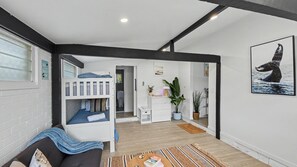 A modern room with a bunk bed, a desk, a chair, and a large window. - Vitamin Sea - Rainbow Beach (Rainbow Beach)