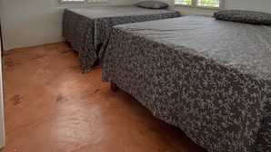 A room with two beds, white walls, and large windows with blinds. - Casa yann  (Las Galeras)