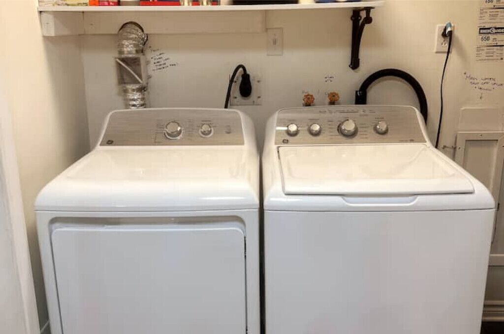 A laundry area with two white front-loading washing machines.