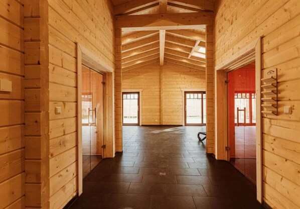 Experience a warm and inviting atmosphere in this cabin-style building with high ceilings and wooden accents.
