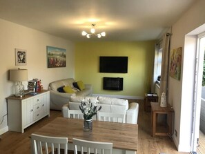 Room | Living area | 55-inch flat-screen TV with digital channels - Just Stay Wales - Marshmallow Cottage (Swansea)