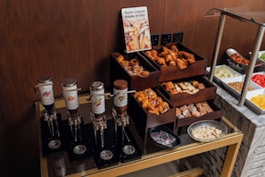 A bakery section with various pastries and jams.
