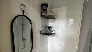 A modern bathroom with a toilet, sink, and shower. - 2 bedroom apartment  (London)