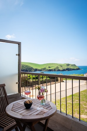 Enjoy breathtaking views of the coastal landscape from this balcony.