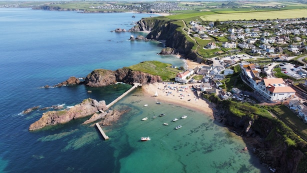 An aerial view of a coastal town with a marina, sandy beach, and residential buildings. - Searush Cove - a beautiful contemporary beachfront apartment (Hope Cove)