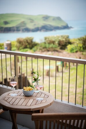 Enjoy a casual meal on the balcony with a scenic view of the surrounding landscape.