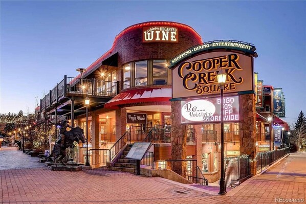 A building with a sign for 'Cooper Square' and 'Decanyed Wine'.