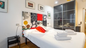 A modern hotel room with a large bed, a bedside table, a nightstand, and a large window. - Santa Reparata Flat by Mmega (Florence)