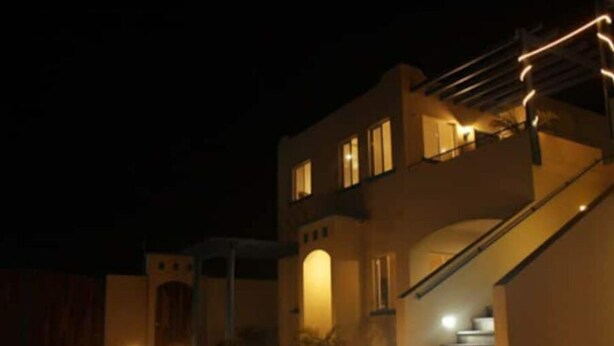 A modern two-story house with a staircase leading to the upper level.