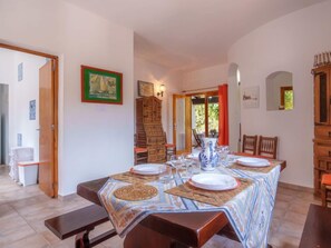 Enjoy meals in this dining area with a long table and comfortable seating for all.