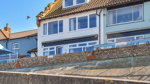 A two-story building with a tiled roof and multiple windows. - 1 bedroom accommodation in Sheringham (Sheringham)