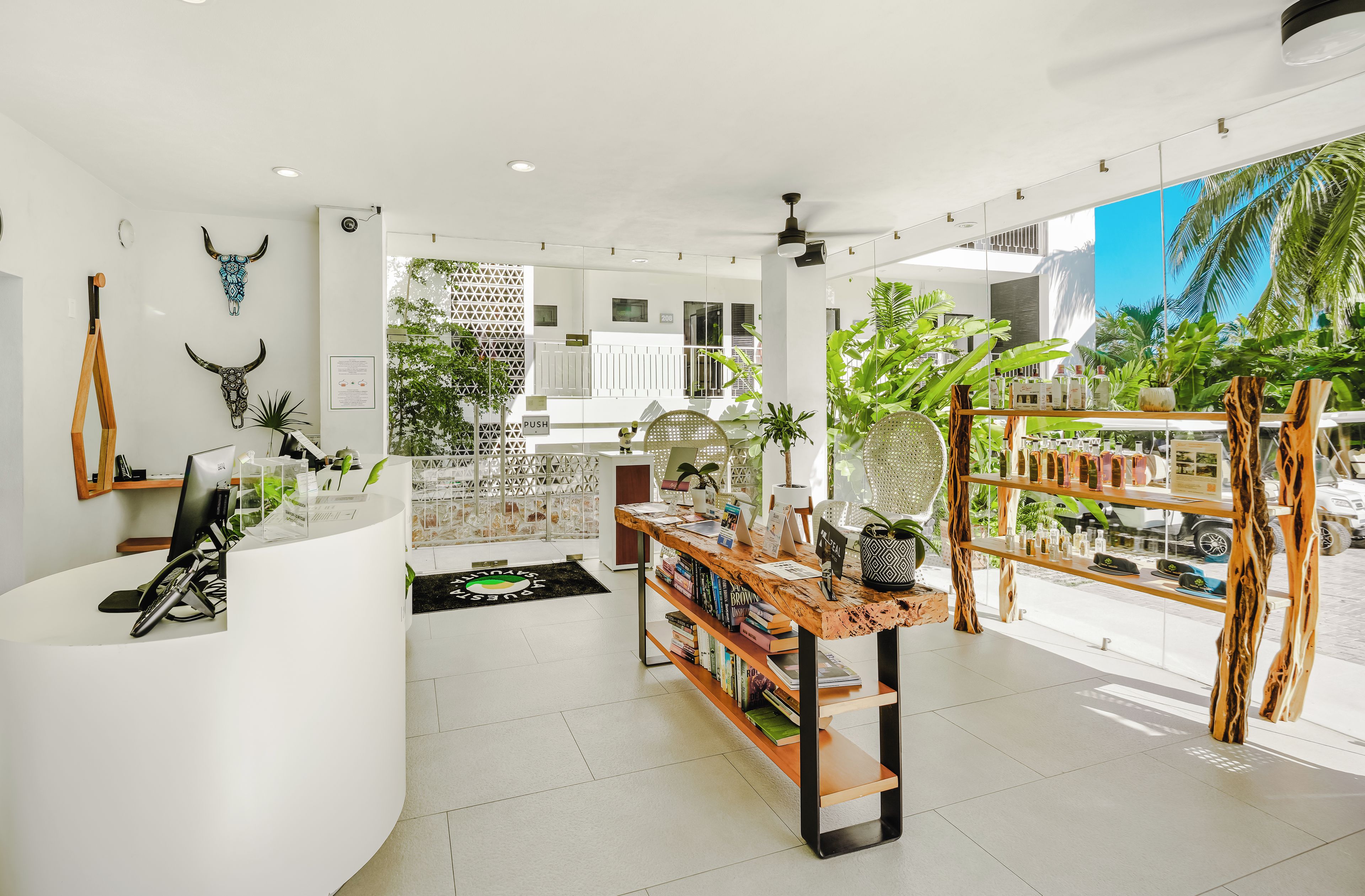 A modern interior with a reception desk, bookshelves, and a variety of decorative items.