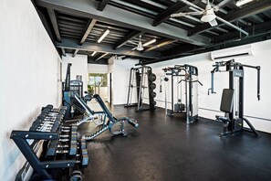 A gym with various exercise equipment, including weight machines and free weights. - La Puesta (Sayulita)