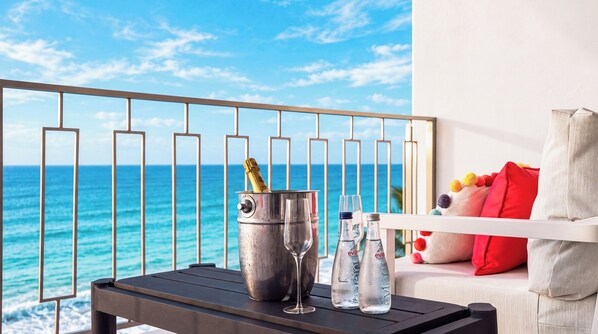 A balcony with a view of the ocean, a metal bucket with a bottle, two glasses, and a bottle of Evian water. - La Puesta (Sayulita)