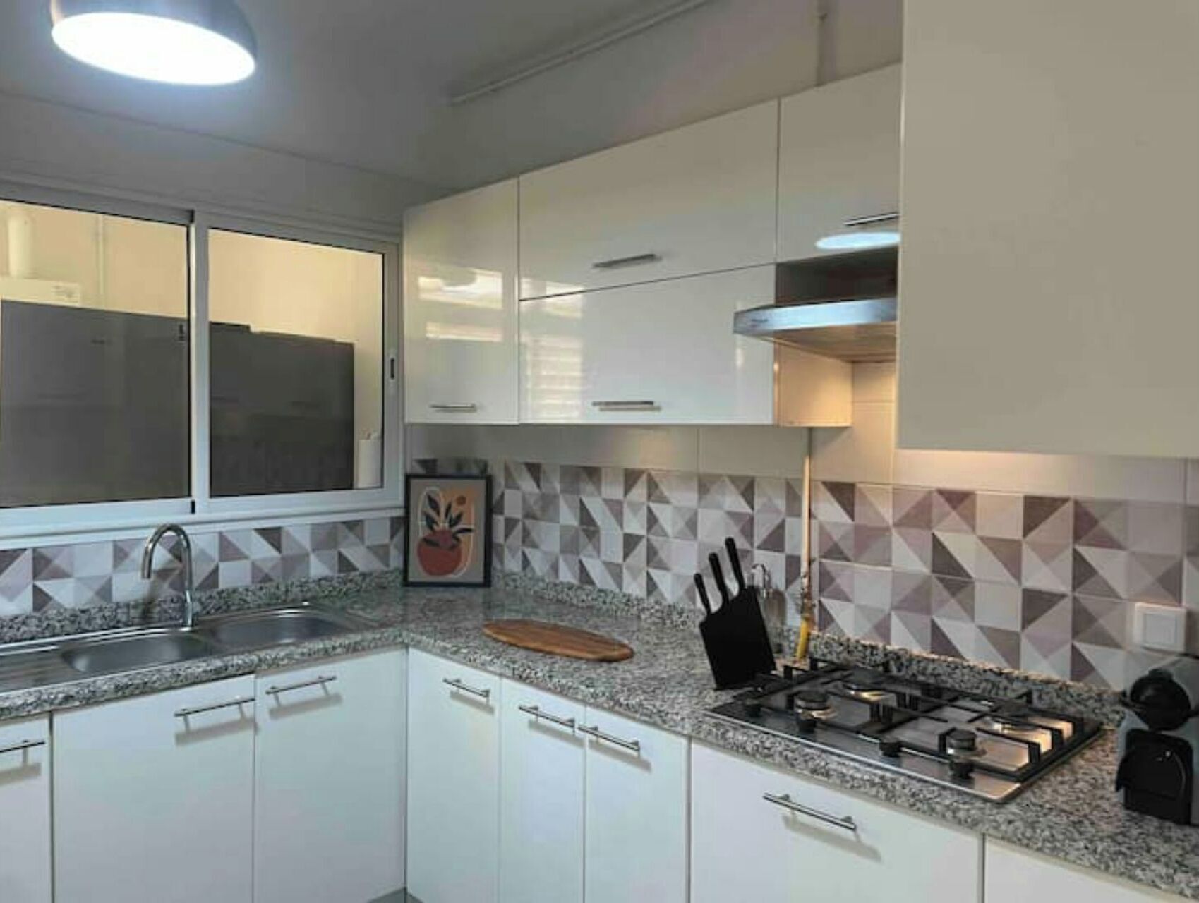 Fridge, stovetop, dishwasher, coffee/tea maker