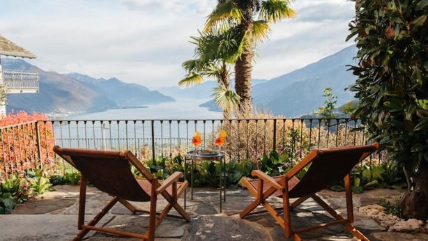 Two wooden chairs facing a stone patio with a view of mountains and a lake. - Carosa - Luxusberghaus mit Seeblick (Peglio)