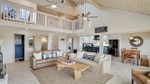 A spacious living area with a high ceiling, a balcony, a kitchen, and a dining area. - Lake Home with Private Pool, Games, Views! 100 yds to Marina w boat launch! (Strawn)