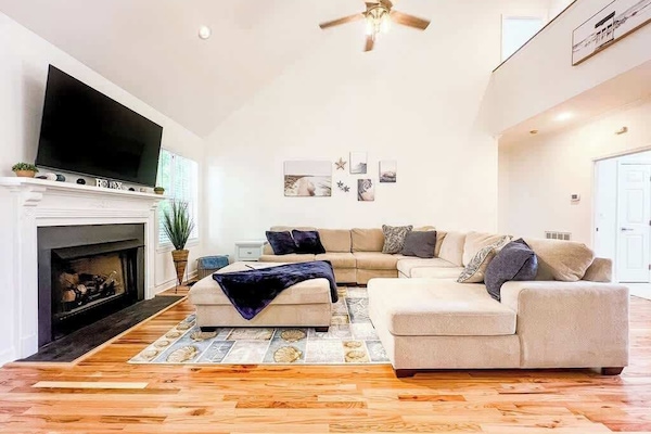 Living space with a huge couch and TV for the whole group to hang out