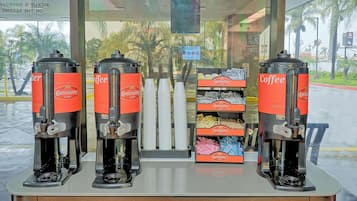 Four coffee dispensers labeled 'Community Coffee' with a sign indicating 'Welcome, please use the back door' and 'No parking'.