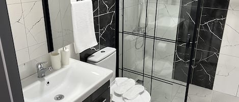 Shower, rainfall showerhead, hair dryer, towels