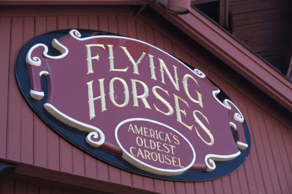 A sign for 'Flying Horses' with the text 'America's Oldest Carousel'.