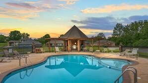 A swimming pool with a wooden deck, lounge chairs, and a gazebo. - Table Rock Landing Resort (Eureka Springs)