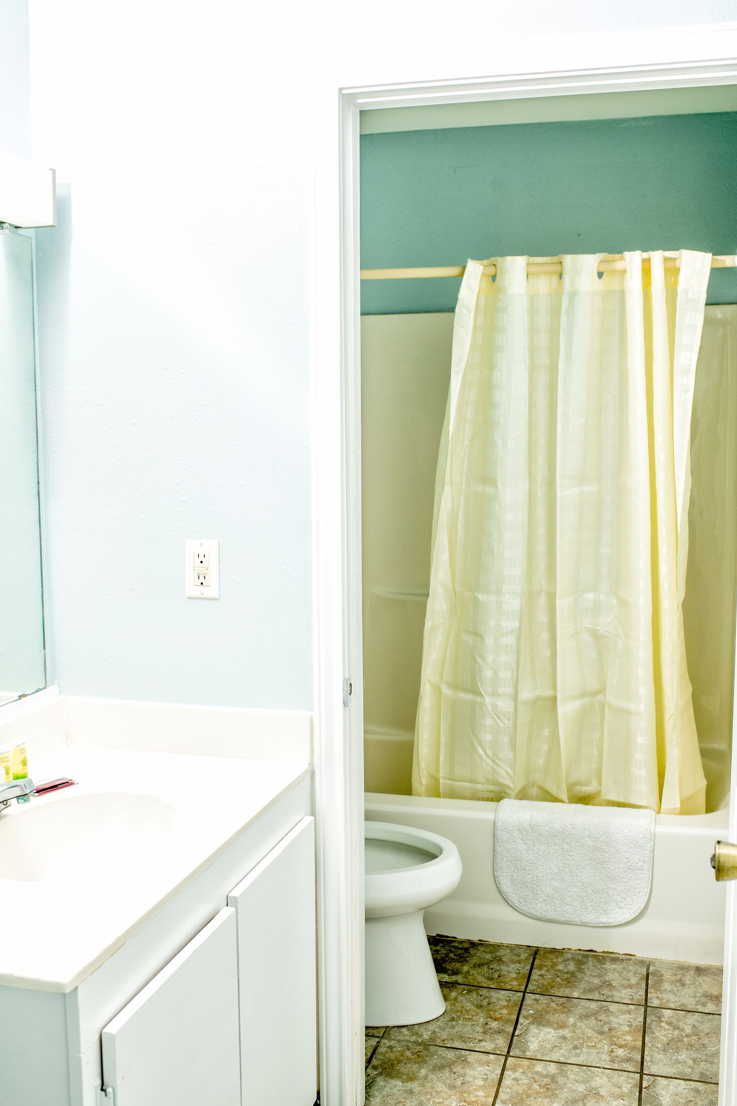 A bathroom with a toilet, a sink, and a bathtub.