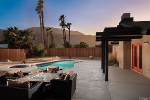 A backyard with a swimming pool, outdoor furniture, and a pergola. - Palm Springs Haven with Heated Pool and Hot Tub! (Palm Springs)
