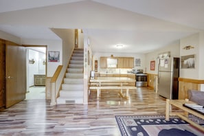 A spacious kitchen with a central island, wooden cabinets, and a stainless steel refrigerator. - Lakefront Phelps Cabin w/ Boat Dock & Water Toys! (Phelps)