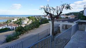 A residential area with a paved road, a tree, and houses in the background. - CASA JOSI with awesome views to the sea at Monte Pego (Pego)